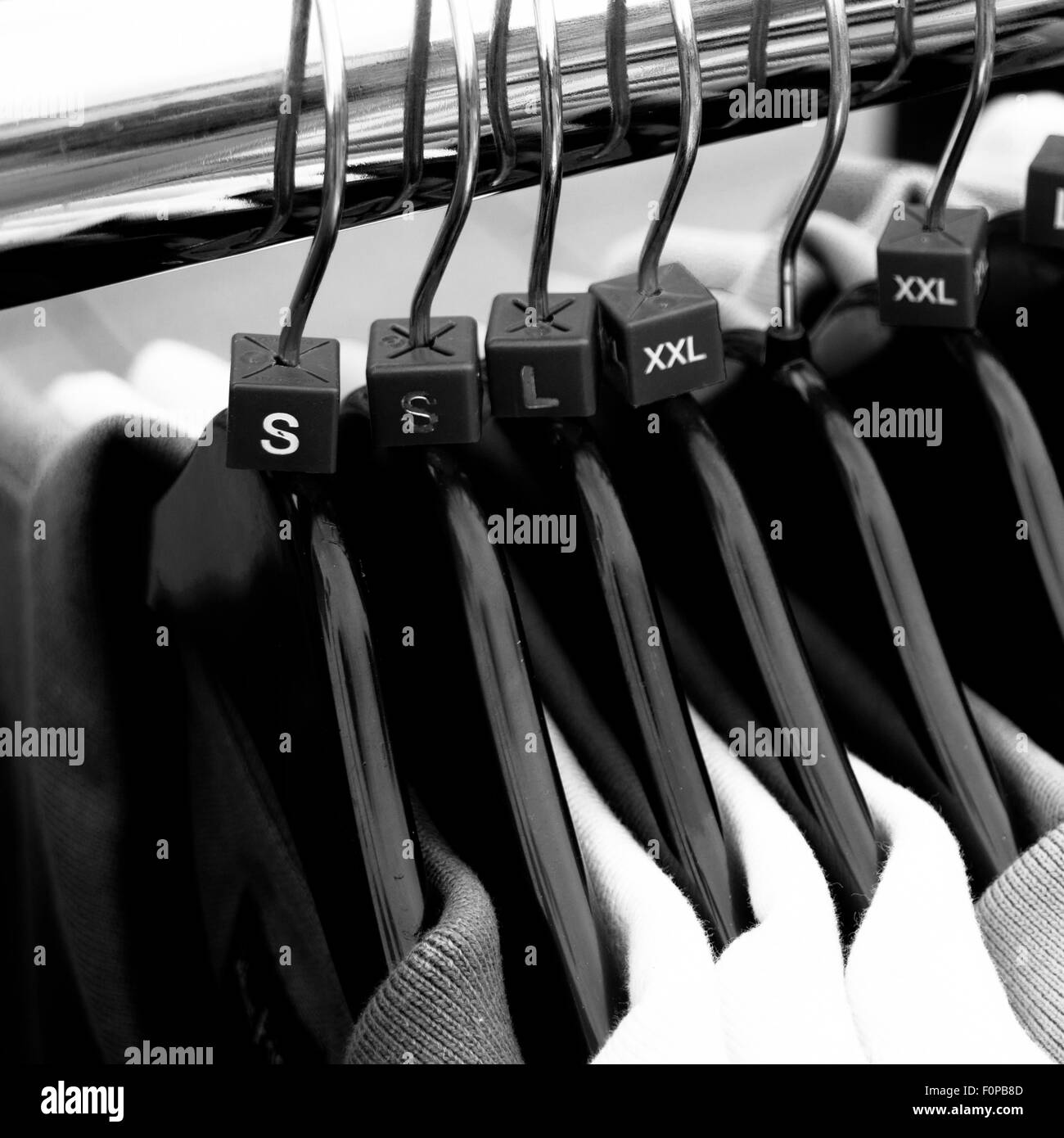 Men`s clothes sizes on coat hangers Stock Photo Alamy